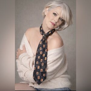 💯% silk tie. Black orangey bronze layered on cream light charcoal